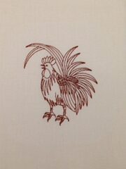 A Fancy Rooster Embroidered Flour Sack Towel is embroidered on a piece of cloth.