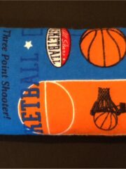 A blue and orange Basketball Comfy Corn Bag with basketballs on it.