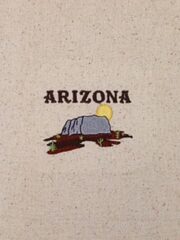 A Arizona Sunrise Embroidered Osnaburg Towel with the word arizona on it.