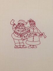 A Christmas card with Santa and Mrs. Claus on it.