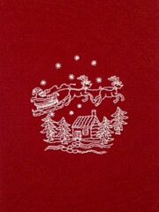A red towel with Reindeer In Flight on it.