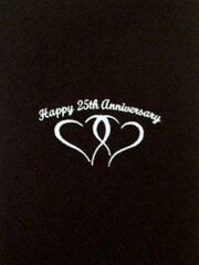 A black napkin with the words "Happy 25th Anniversary" on it.