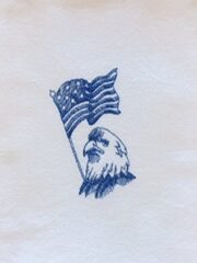 A napkin with an Eagle Head & U.S. Flag holding an american flag.