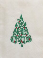 A Merry Christmas Tree with the words merry christmas embroidered on it.