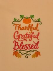 A shirt with the words "Thankful Grateful Blessed" (wheat) on it.