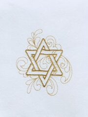 A Star Of David Embroidered Deluxe Flour Sack Towel Gold Thread on White DFS on a white napkin.